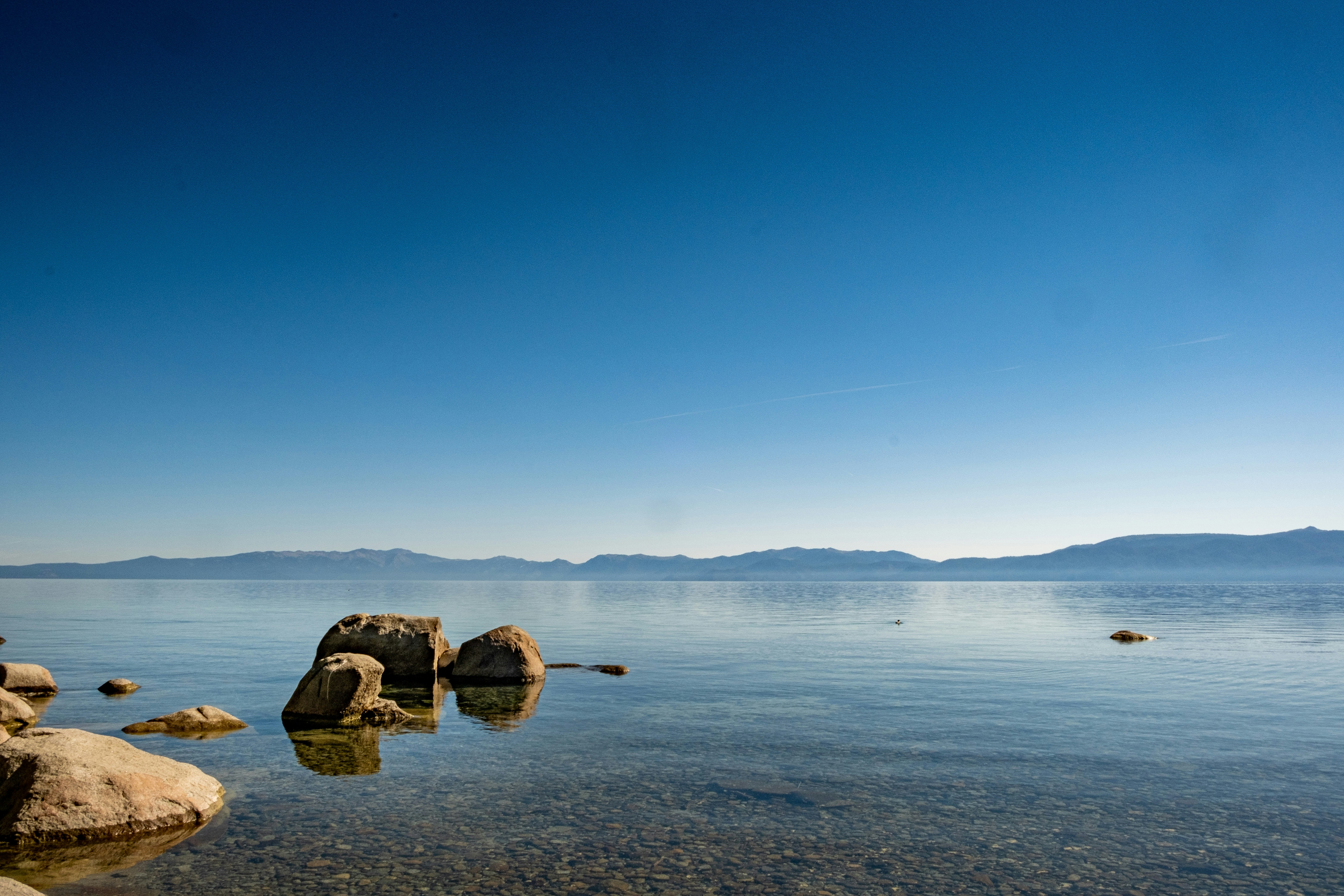 brown rock on body of water during daytime